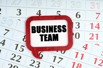 On the calendar, a red plaque with the words inside - Business team