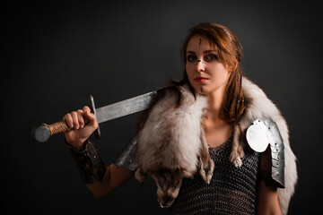 Portrait of a medieval woman warrior in chain mail armor and polar fox fur on her shoulders...