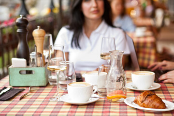 Young woman drinking a coffee in a cafe terrace