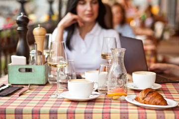 Young woman drinking a coffee in a cafe terrace