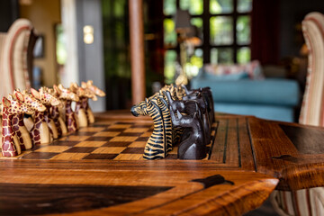 chess on the table with figures in the form of wild animals of africa 