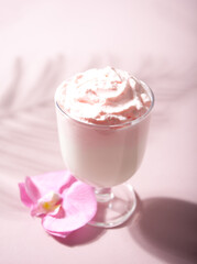 Glass of rose or strawberry iced Dalgona whipped drink coffee
