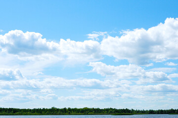 Obraz premium beautiful landscape dark blue lake, green forest and cloudy sky..