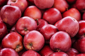 Fototapeta na wymiar Glossy red apples displayed on street food market, closeup detail