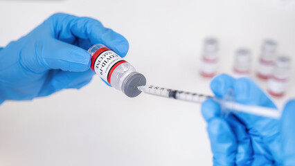 Doctor filling syringe medication with Covid-19 coronavirus vaccine. Fight against Covid-19 coronavirus Concept.