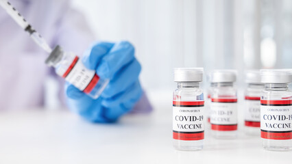 Doctor filling syringe medication with Covid-19 coronavirus vaccine. Fight against Covid-19 coronavirus Concept.