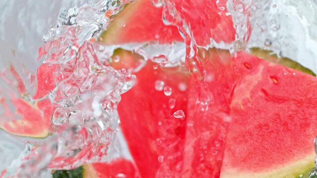 Super Slow Motion Shot of Melon Slices Falling Into Water Whirl at 1000 fps.
