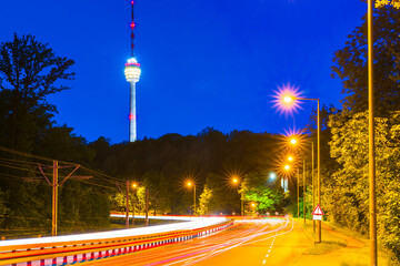 Fototapeta na wymiar Germany, Night in stuttgart city, illuminated strees with traffic leading to famous television tower building of the skyline