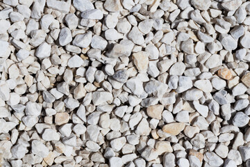 Small white stones (pebbles). Background texture. High quality photo