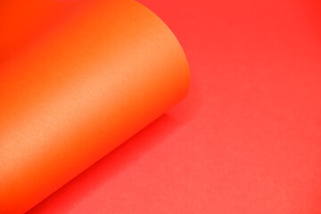 Orange cardboard on a red background. The texture of the cardboard.