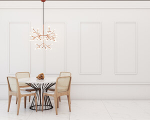 Dining room with table, chairs with Indian straw seats, chandelier and white walls with boiserie details.