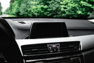 Screen multimedia system on dashboard in a modern car.