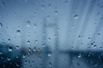 Vidyasagar Setu (Bridge) over river Ganges, known as 2nd Hooghly Bridge in Kolkata,West Bengal, India. Abstract image shot aginst glass with raindrops all over it, monsoon image of Kolkata.