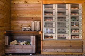 Wooden barn with vending machine for selling and buying eggs.
