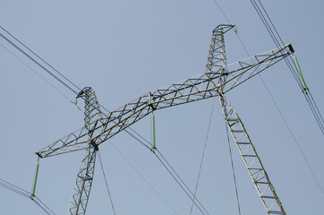 Metal structure of an electric mast against the background of the sky.