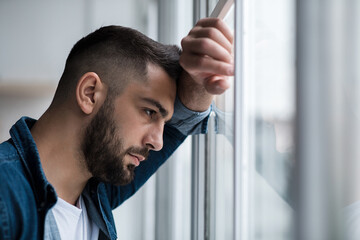 Depressed caucasian man losing job and heartbroken at same time alone, feeling bad and expresses...