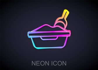 Glowing neon line Cat litter tray with shovel icon isolated on black background. Sandbox cat with shovel. Vector