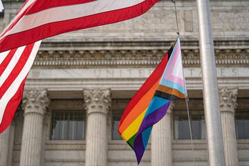 Waving Pride flag next to the flag of USA