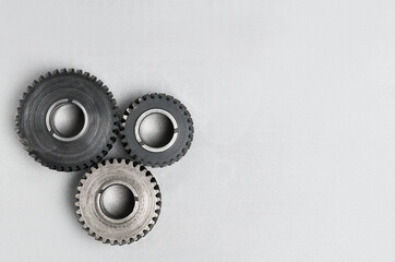 three gears on a gray background