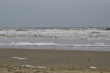 Surf on a beach of the North Sea on a stormy day