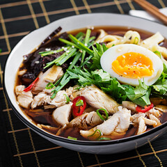 Miso soup. Japanese ramen soup with chicken, egg, nori and  nipposinica on dark background.