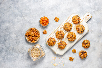 Fototapeta na wymiar Homemade oatmeal cookies with raisins and walnuts.