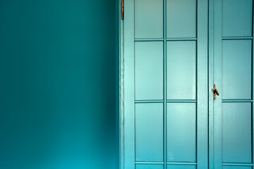 Cyan blue wall with cupboard stylish interior,modern blue cupboard door background texture...