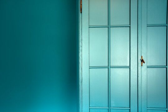 Cyan blue wall with cupboard stylish interior,modern blue cupboard door background texture beautiful luxury house decoration