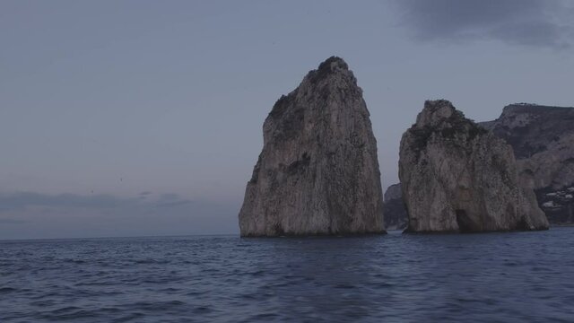 Aerial Drone footage view of Faraglioni Rocks in Sea in Capri Naples Costiera Amalfitana Italy Europe // no video editing
