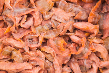 Lots of pieces of salted, finely chopped, red fish, close-up.