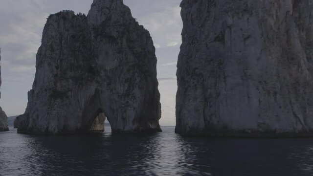 Aerial Drone footage view of Faraglioni Rocks in Sea in Capri Naples Costiera Amalfitana Italy Europe // no video editing
