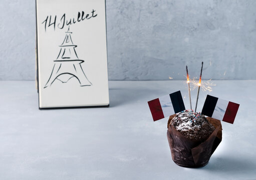 Cupcake, mafia with French flags and sparklers. The concept of the holiday July 14 Bastille Day, a public holiday of France