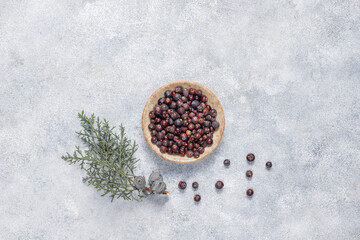 Dried juniper berries in a small bowl.