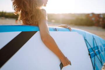 Surfer woman  during summer travel beach vacation.Young woman with glanders at the beach. Extreme...