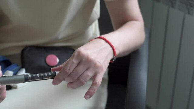 Diabetes woman injects insulin in her arm with insulin pen needle, diabetes patient makes an arm subcutaneous insulin pen injection at home, diabetes world day.