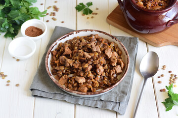 A delicious and hearty lunch for the family: lentils with meat and vegetables, baked in clay pots.