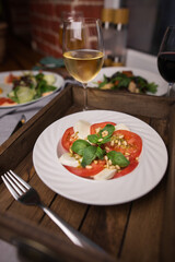 caprese salad with a glass of white wine