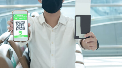 Traveler shows health passport of vaccination certification on phone at airport, to certicy that have been vaccinated of coronavirus covid-19
