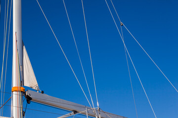 The mast of a sailing yacht, with stretched ropes, without sails.