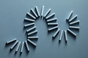 Light Blue wood domino pieces on light blue background. Leisure games concept.