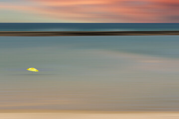 Beautiful Sunset at sea with a umbrella in the water, Barra de São Miguel, Alagoas, Brazil. fine art.