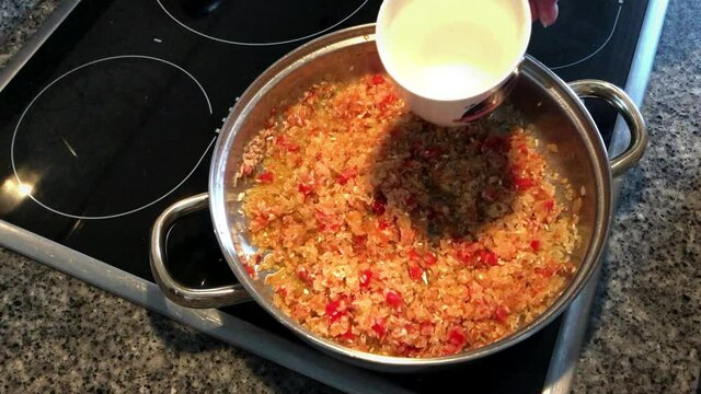 Cooking rice with prawns and tuna. Typical Spanish food paella