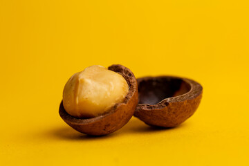 delicious and high-calorie macadamia nut on a yellow background