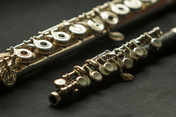 Musical wind instrument piccolo flute and brass flute. High quality photo - obrazy, fototapety, plakaty