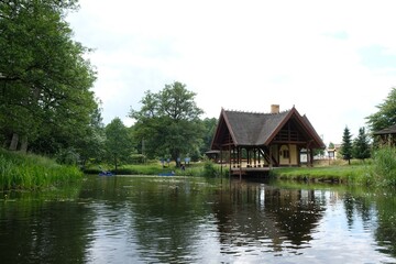Fototapeta na wymiar A wooden house by the river Zbrzyca, a resting place for canoeists. Laska, Bory Tucholskie, Poland