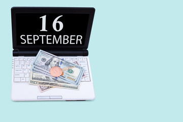Laptop with the date of 16 september and cryptocurrency Bitcoin, dollars on a blue background. Buy or sell cryptocurrency. Stock market concept.