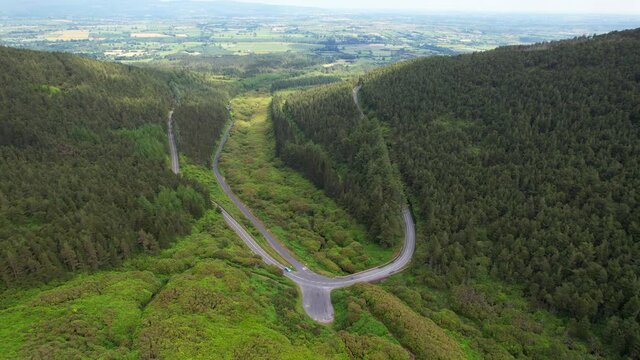 A Car Goes By The Tri Spear Shaped Roads Near The Vee Pass In The Knockmealdown Mountains In Clogheen County Tipperary, Ireland