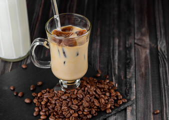 Cold drink: milk with frozen ice cubes . Iced coffee in a tall glass