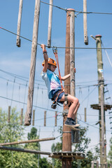 having fun in rope climbing centre in hot summer day