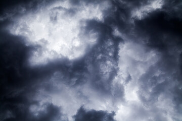 Abstract almost black-and-white pattern of gloomy skies before the storm. . Or the clouds or puffs of smoke. Blur back and white concept. The pattern in the sky is very original and unusual.